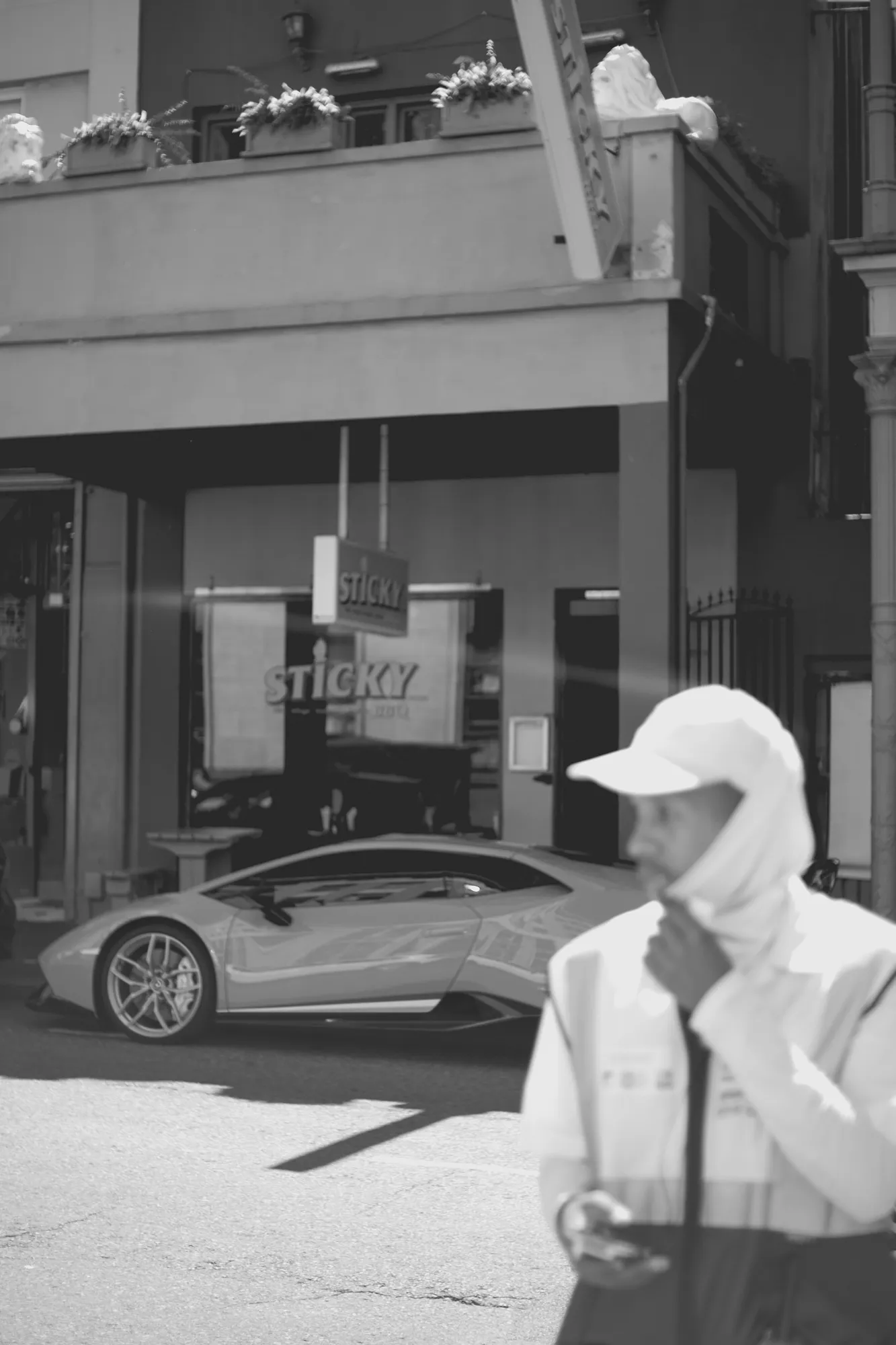 2022-02-17 - Cape Town - Parking gaurd crossing road in front of parked lamborghini